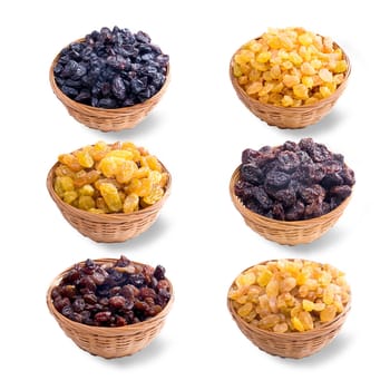 different varieties of raisins in a straw plate on white background