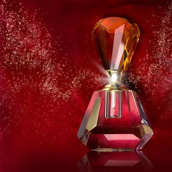 bottle of perfume on a dark red background
