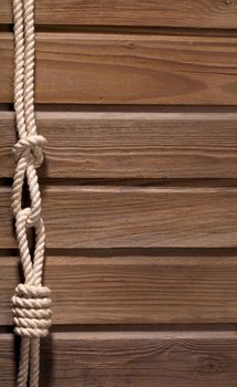 Image of old texture of wooden boards with ship rope.