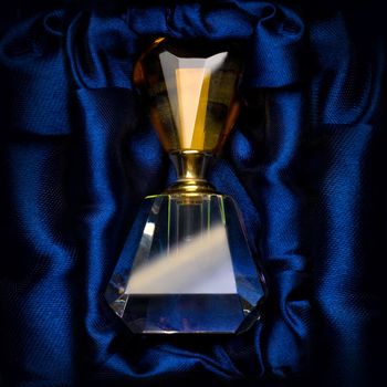 bottle of perfume on a dark blue background