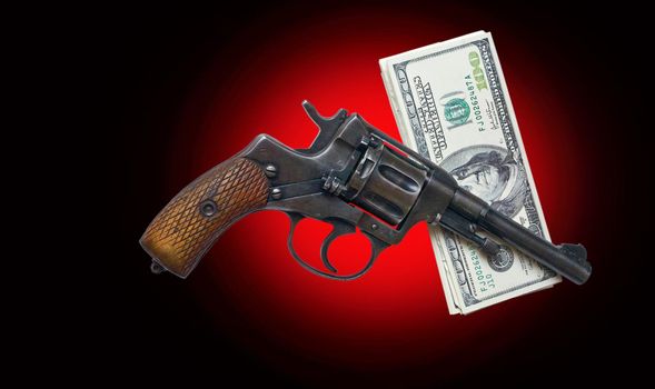 old revolver and money on a darkly red background