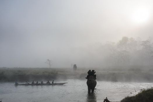 SAURAHA, NEPAL - CIRCA DECEMBER 2014: Tourists doing an elephant safari in Chitwan National Park.