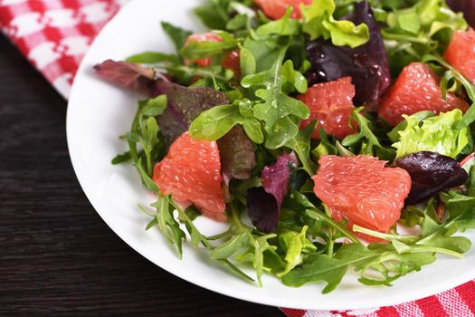 Grapefruit salad, a mix of lettuce, arugula and olive dressing. Dietary menu. Proper nutrition. Vegetarian food.