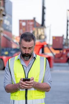 Portrait of engineer worker of factory technician stand with using mobile phone and look surprise emotion in workplace area. Concept of good support best successful for industrial business.