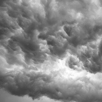 Rainy cloudy sky background. Dark ominous grey storm clouds. Dramatic sky background.