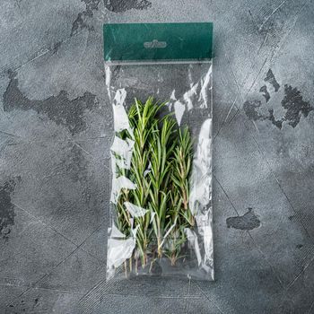 Rosemary in plastic bag set, on gray background, top view flat lay