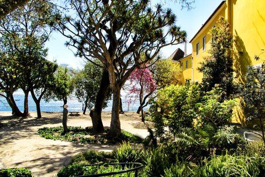 Beautiful yellow house with colorful garden in Oeiras, Lisbon, Portugal