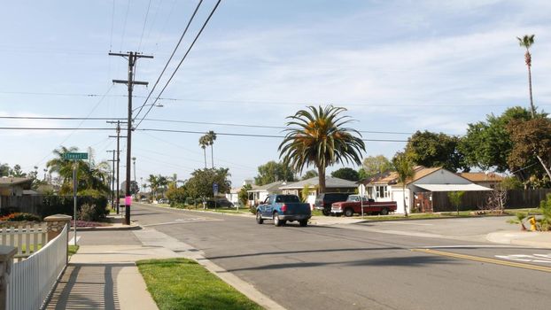 Houses on suburban street in California USA, Oceanside. Generic buildings in residential district near Los Angeles. Real estate property exterior. Tropical gardens, palms near typical american homes.