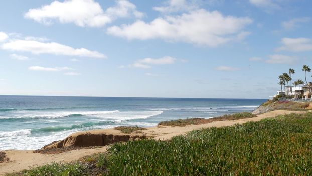 Seascape vista point, viewpoint in Carlsbad, California coast USA. Frome above panoramic ocean tide, blue sea waves, steep eroded cliff. Coastline shoreline overlook. Green ice plant succulent lawn.