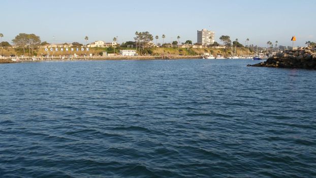 View of sea water from sailing boat or yacht, Oceanside harbor, summer vacations in California USA. Seascape from sailboat in port, tropical marina harbour. Pacific ocean coast, whale watching tour.
