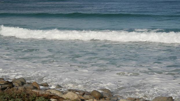 Ocean waves and rocks, Monterey, Northern California, USA. 17-mile drive near Big Sur, seaside golf tourist resort on Pacific Coast Highway. Splashing water and sea breeze of Pebble beach. Road trip.