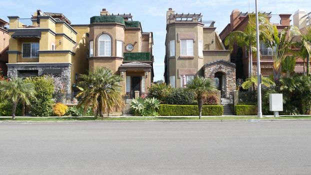 California typical suburban street, tropical Oceanside USA. Different colorful houses row. Generic american homes, buildings facade, townhouse exterior architecture. Residential district real estate.
