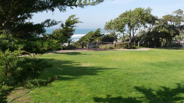 Seagrove recreation beach park in Del Mar, California USA. Seaside garden with lawn in waterfront resort. Green grass and ocean coast view from above. Picturesque coastline vista point on steep hill.