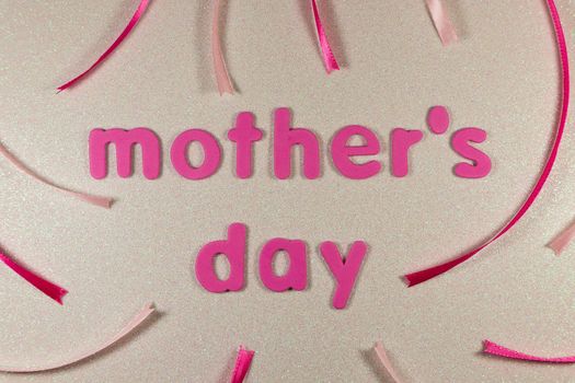 Mother's day themed layout with pink text and ribbons on textured glitter background