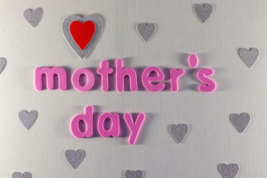 Mother's day themed layout with silver hearts pattern and pink text on white background