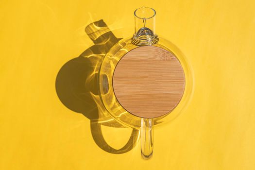 glass teapot with a hard shadow on a colored background. High quality photo