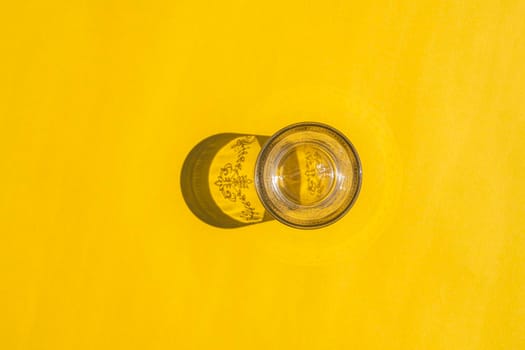 glass with a hard shadow on a colored background. High quality photo