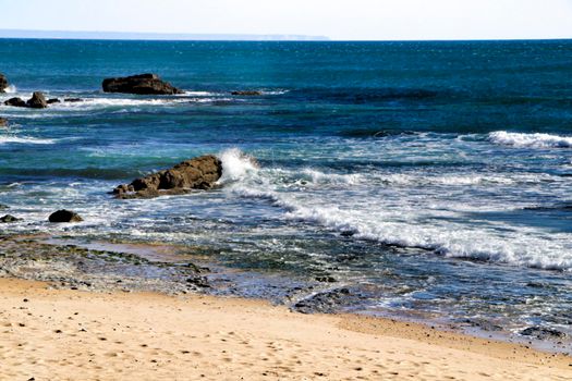 Beautiful Azarujinha beach with rock formations in Estoril, Lisbon, Portugal, in a sunny day of winter