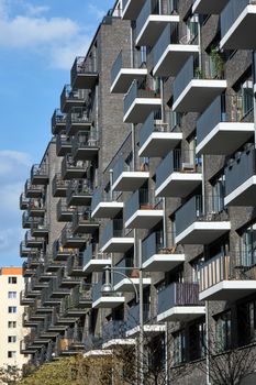 New gray apartment building made of bricks seen in Berlin, Germany