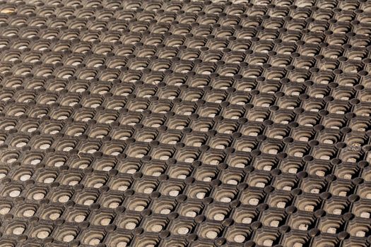 texture and background of used dusty cellular rubber floor mat - perspective view