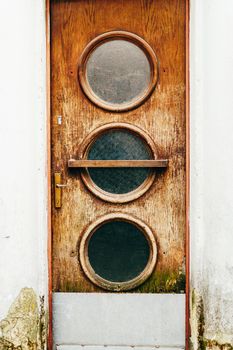 Old yellow, brown, red doors. Wood texture. Old shabby irradiated paint