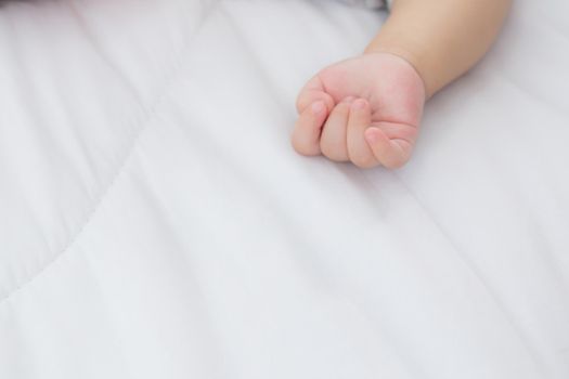 Portrait of asian little baby girl sleeping on bed in the bedroom at home, newborn napping with cozy and relax, infant innocence in bedtime, happy toddler cute, growth of child and emotion, indoors.