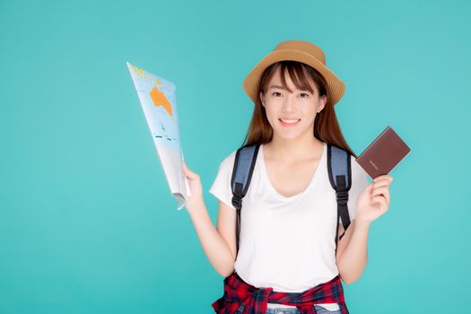 Beautiful happy young asian woman travel holding passport and looking a paper map isolated on blue background, asia girl search journey with direction in vacation trip with cheerful for leisure.
