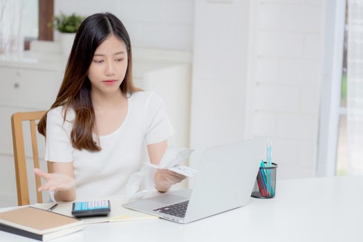 Young asian woman calculating expenses household about finance and frustrated on desk at home, girl checking bill having stress and worried, debt and tax, expression and emotion, business concept.
