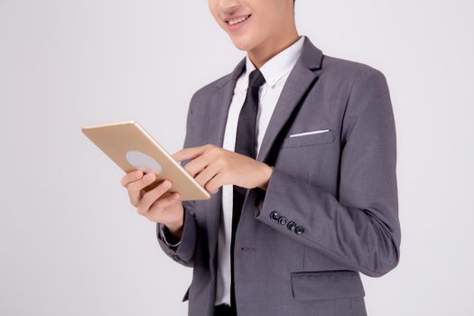 Portrait young asian business man in suit standing using tablet computer to internet isolated on white background, businessman confident touch screen digital pad with success, communication concept.
