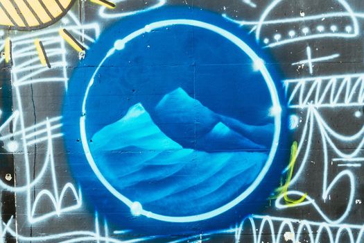 Graffiti mountains and starry sky. Drawing on the wall. Street artists.
