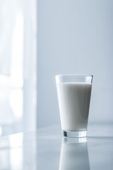 Dairy, healthy nutrition and breakfast concept - World Milk Day, full glass on marble table