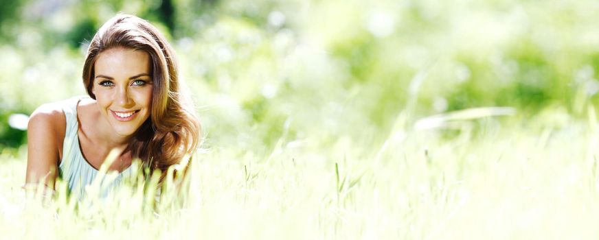 Portrait of attractive green eyes girl smiling in spring park nature background