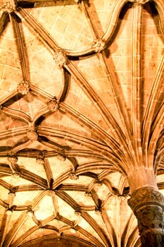 Arches and monumental columns with carved stone details of Santa Maria de Belem in Lisbon, Portugal