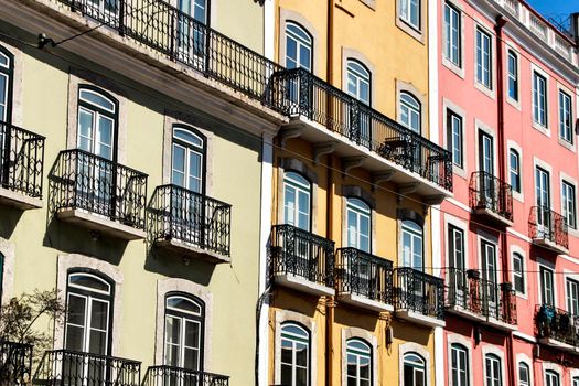Old colorful and majestic tiled facades with vintage streetlight in Lisbon streets in Spring.