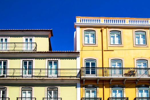 Old colorful and majestic tiled facades with vintage streetlight in Lisbon streets in Spring.