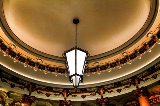 Beautiful coffered ceiling with vintage lamp in a vintage coffe in Lisbon