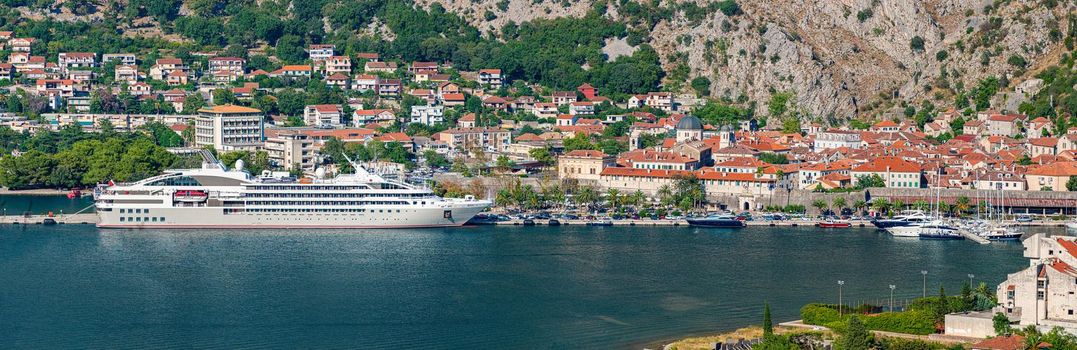 Cruise ship in Kotor, Montenegro, Europe. Panoramic image with cruise liner and old town.