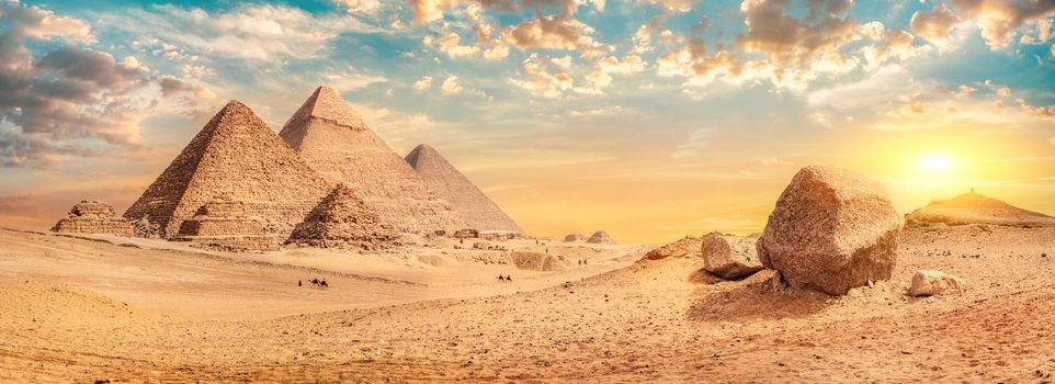 Row of pyramids in desert of Giza at sunset, Egypt