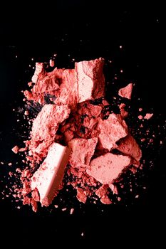 Crushed cosmetics, mineral organic eyeshadow, blush and cosmetic powder isolated on black background, makeup and beauty banner, flatlay design.