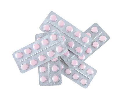 A bunch of pink tablets in blisters isolated on a white background.