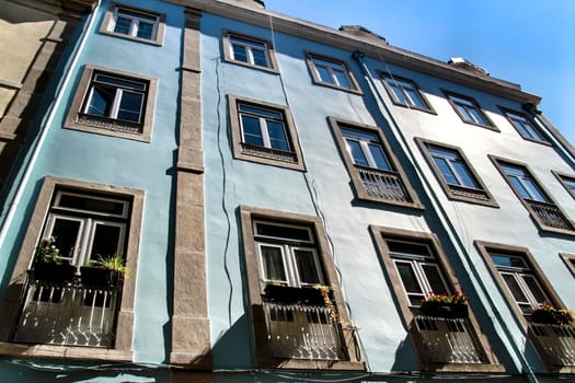 Old colorful and majestic tiled facades with vintage streetlight in Lisbon streets in Spring.