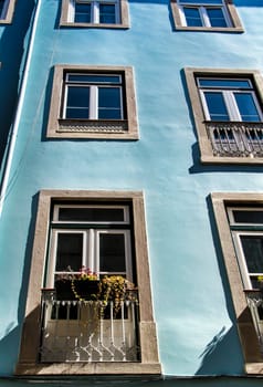 Old colorful and majestic tiled facades with vintage streetlight in Lisbon streets in Spring.