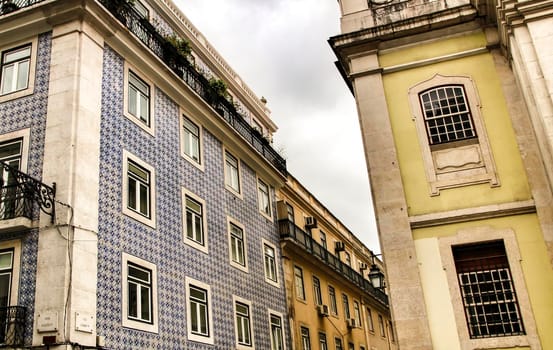 Narrow and colorful streets, majestic facades, windows and balconies of Lisbon, Portugal