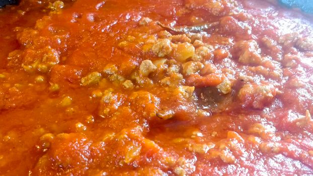 Saucepan with tomato and meat sauce called Bolognese