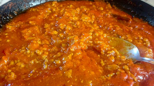 Saucepan with tomato and meat sauce called Bolognese