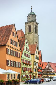 Street in Dinkelsbuhl with historical houses and St. George Minster, Bavaria, Germany