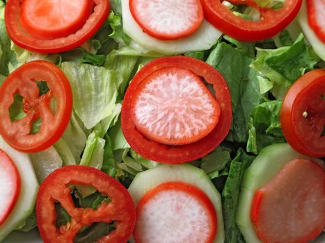 mixed salad with lettuce, tomato and onion closeup