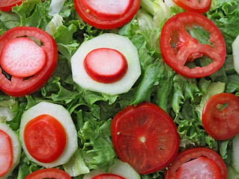 mixed salad with lettuce, tomato and onion closeup
