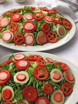 mixed salad with lettuce, tomato and onion closeup