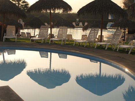 Swimming pool area of hotel with umbrella and beach chair Lima-Peru